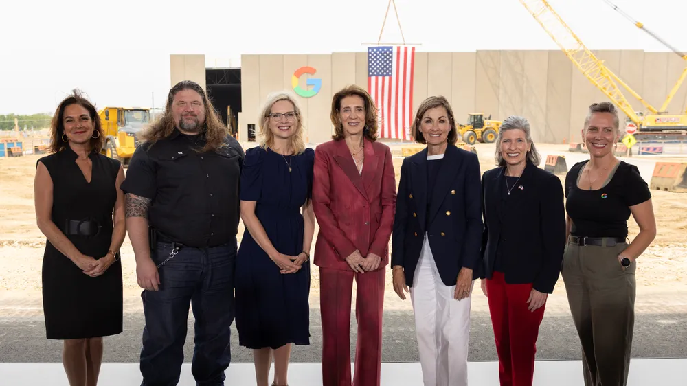 From left: Cedar Rapids Mayor Tiffany O'Donnell; Jebediah Novak, Training Coordinator, Cedar Rapids Electrical Training Center; Rep. Ashley Hinson; Ruth Porat, President and Chief Investment Officer, Alphabet and Google; Gov. Kim Reynolds; Sen. Joni Ernst; and Allie Hopkins, Data Center Operations and Area Lead, Google Data Centers Iowa and Nebraska. The group stands outside the Cedar Rapids Google data center facility during the May 2025 investment announcement.